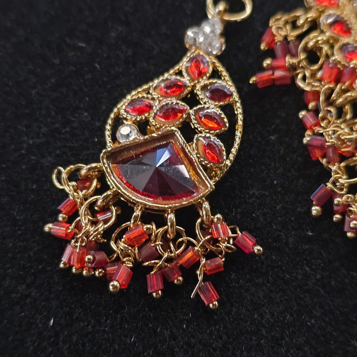 A stunning kundan choker set in gold and red tones