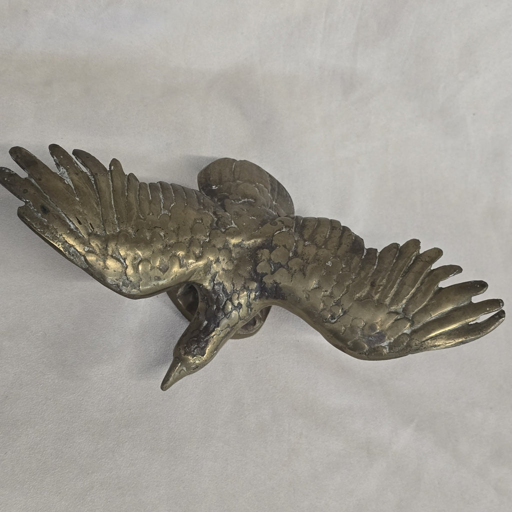 A antique solid and heavy brass free flying eagle