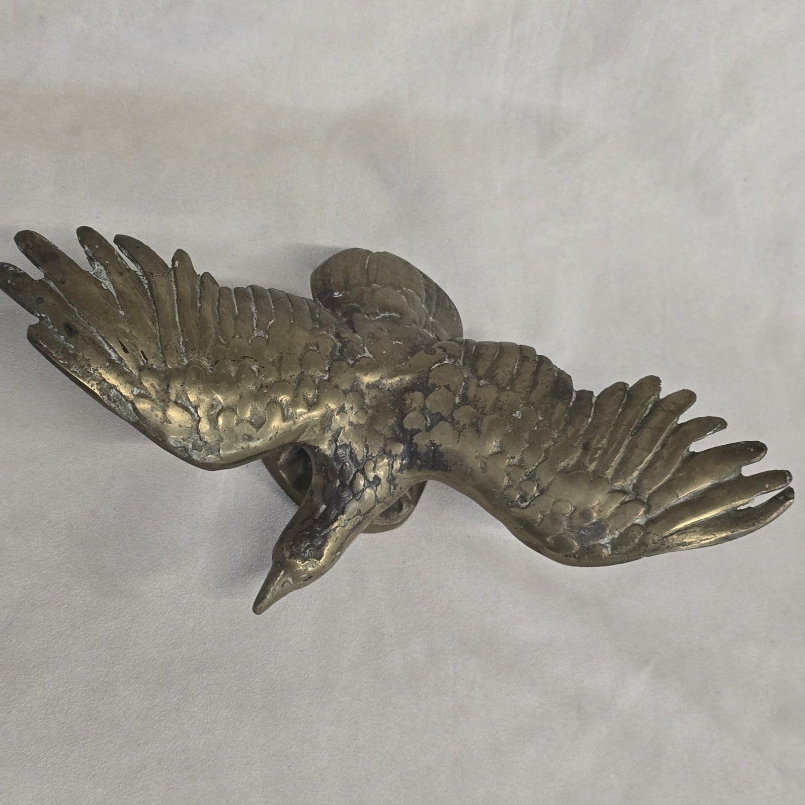 A antique solid and heavy brass free flying eagle