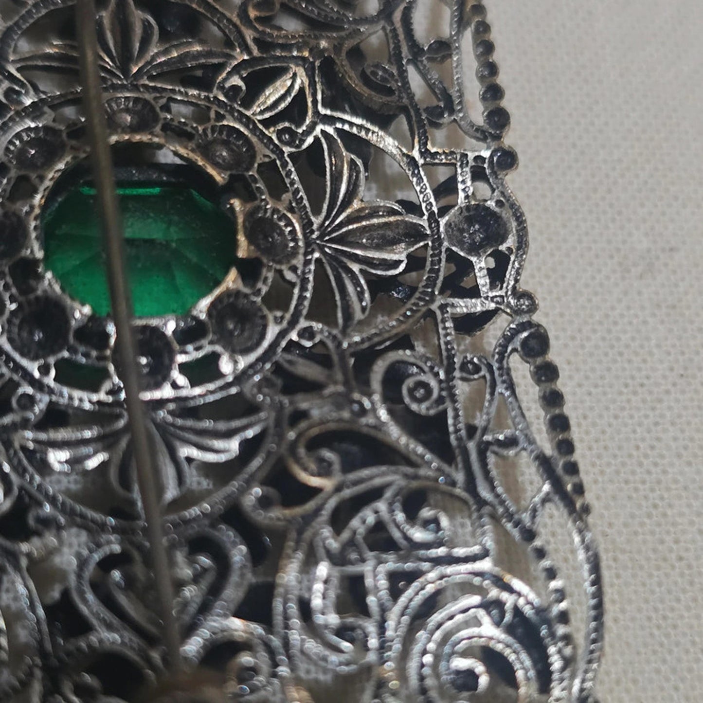 a stunning filigree and emerald green vintage brooch