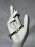 Silver colored bracelet with faux pearls