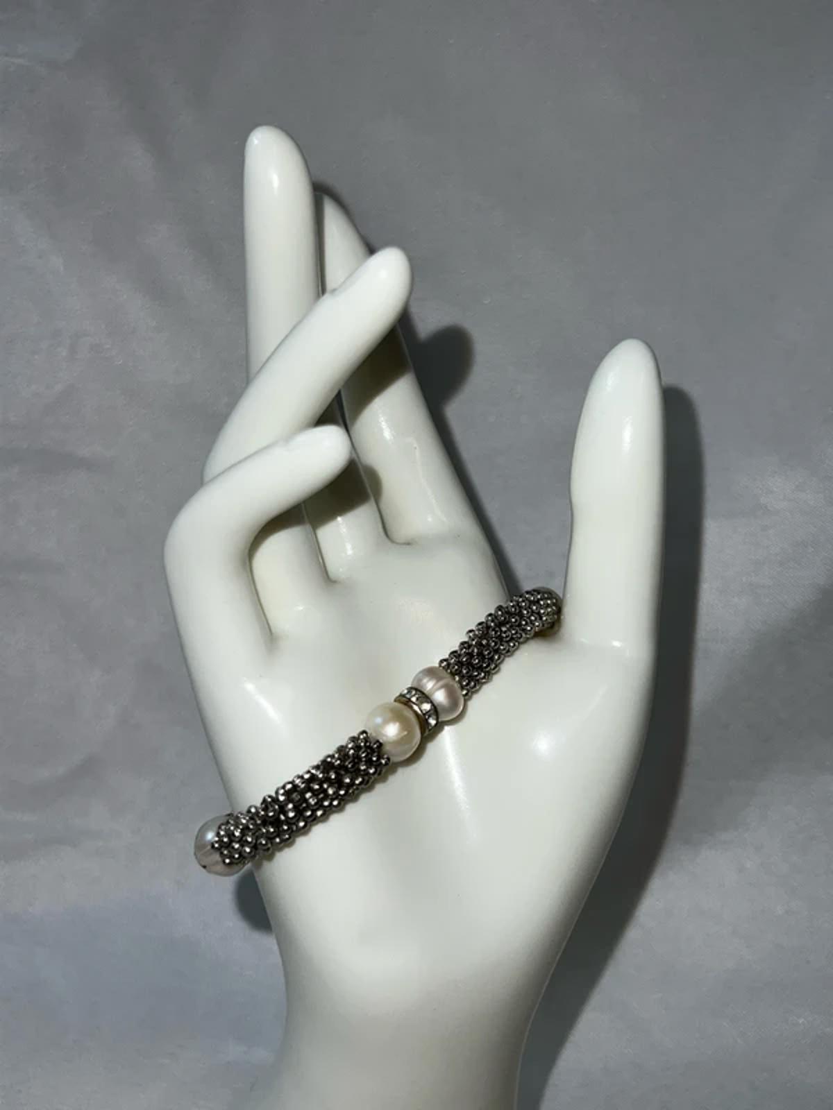 Silver colored bracelet with faux pearls
