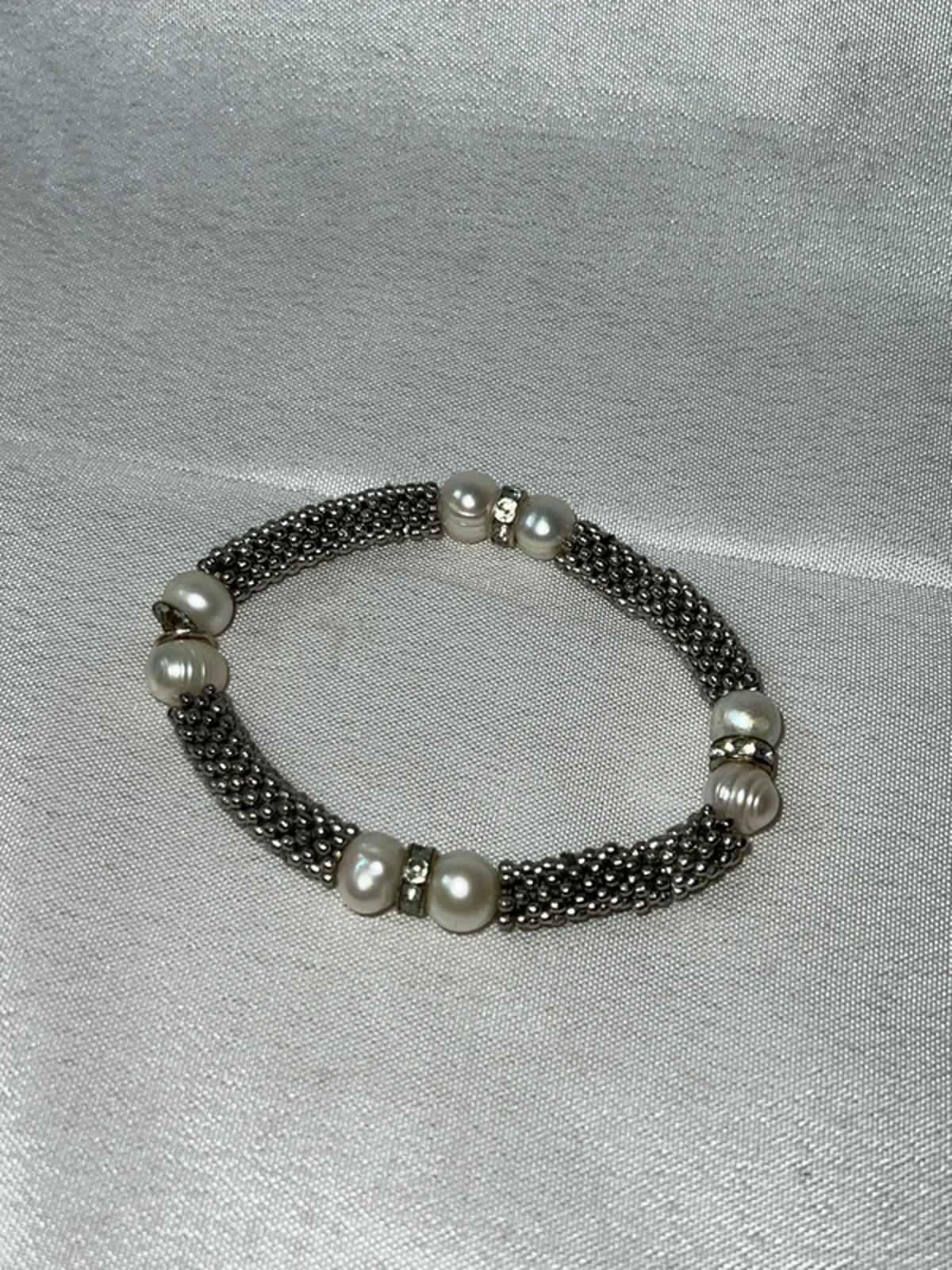 Silver colored bracelet with faux pearls