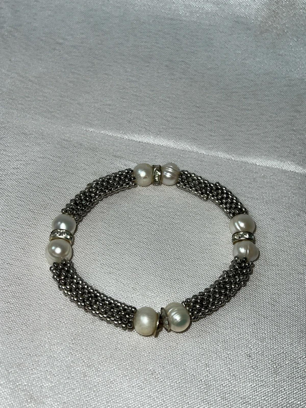 Silver colored bracelet with faux pearls