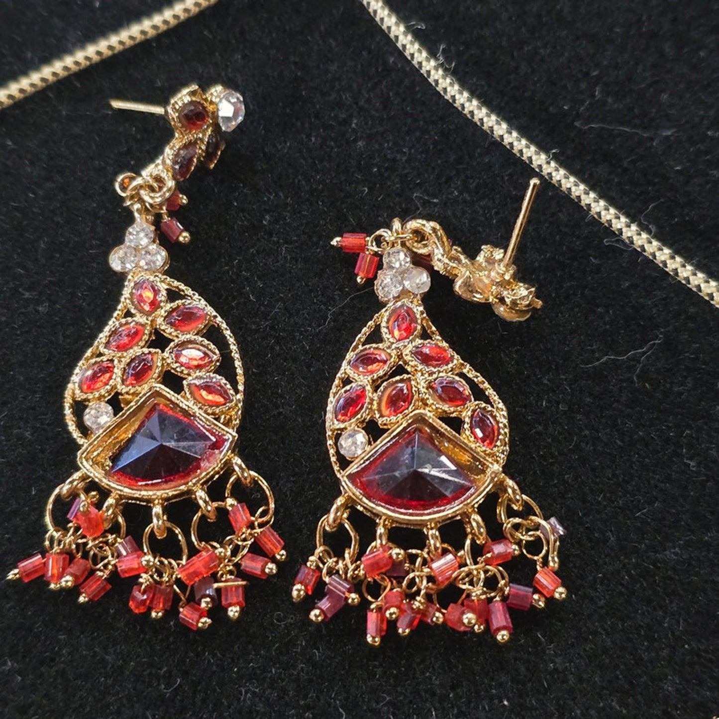 A stunning kundan choker set in gold and red tones