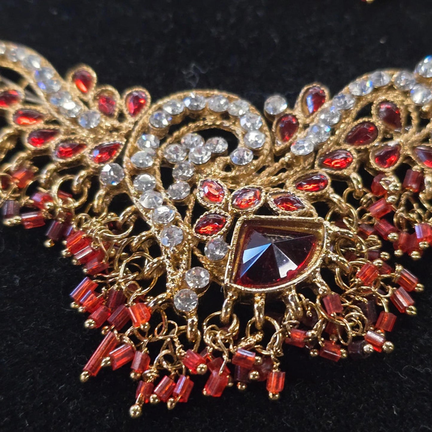 A stunning kundan choker set in gold and red tones