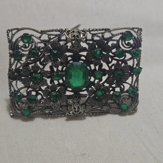 a stunning filigree and emerald green vintage brooch