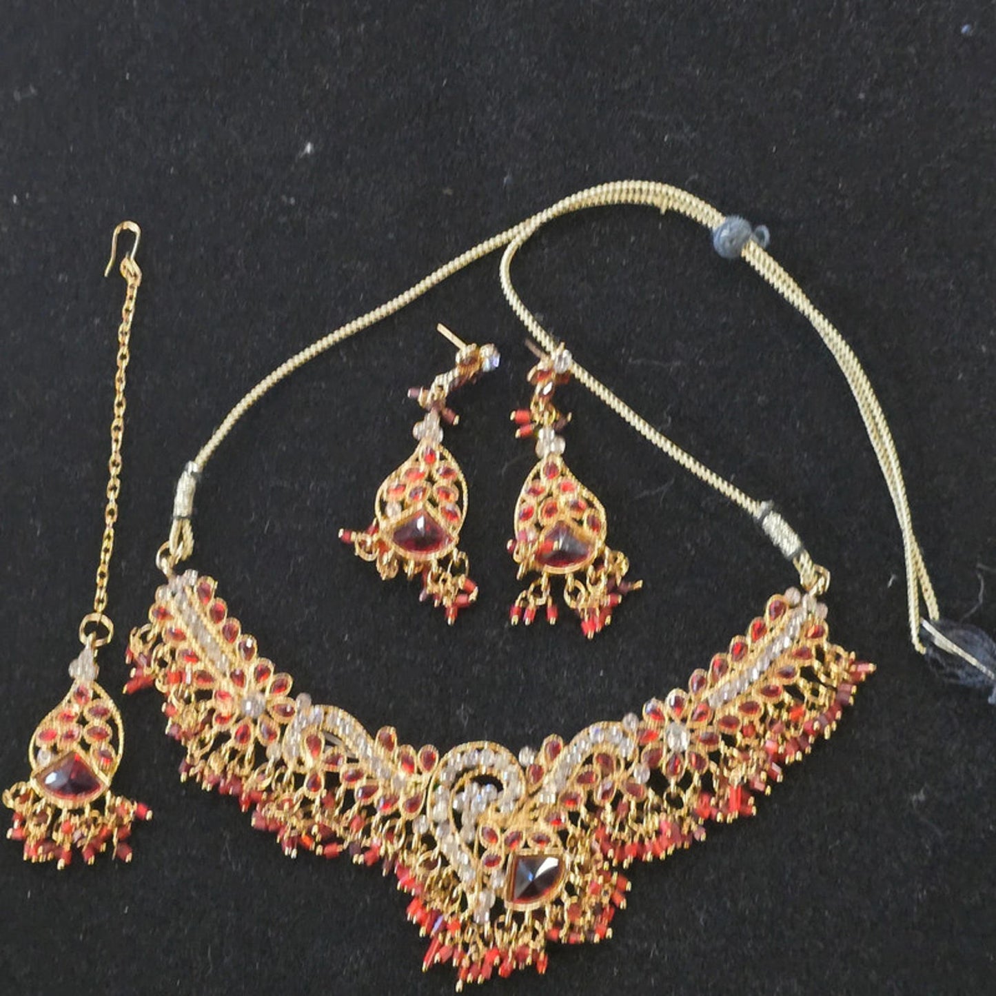 A stunning kundan choker set in gold and red tones