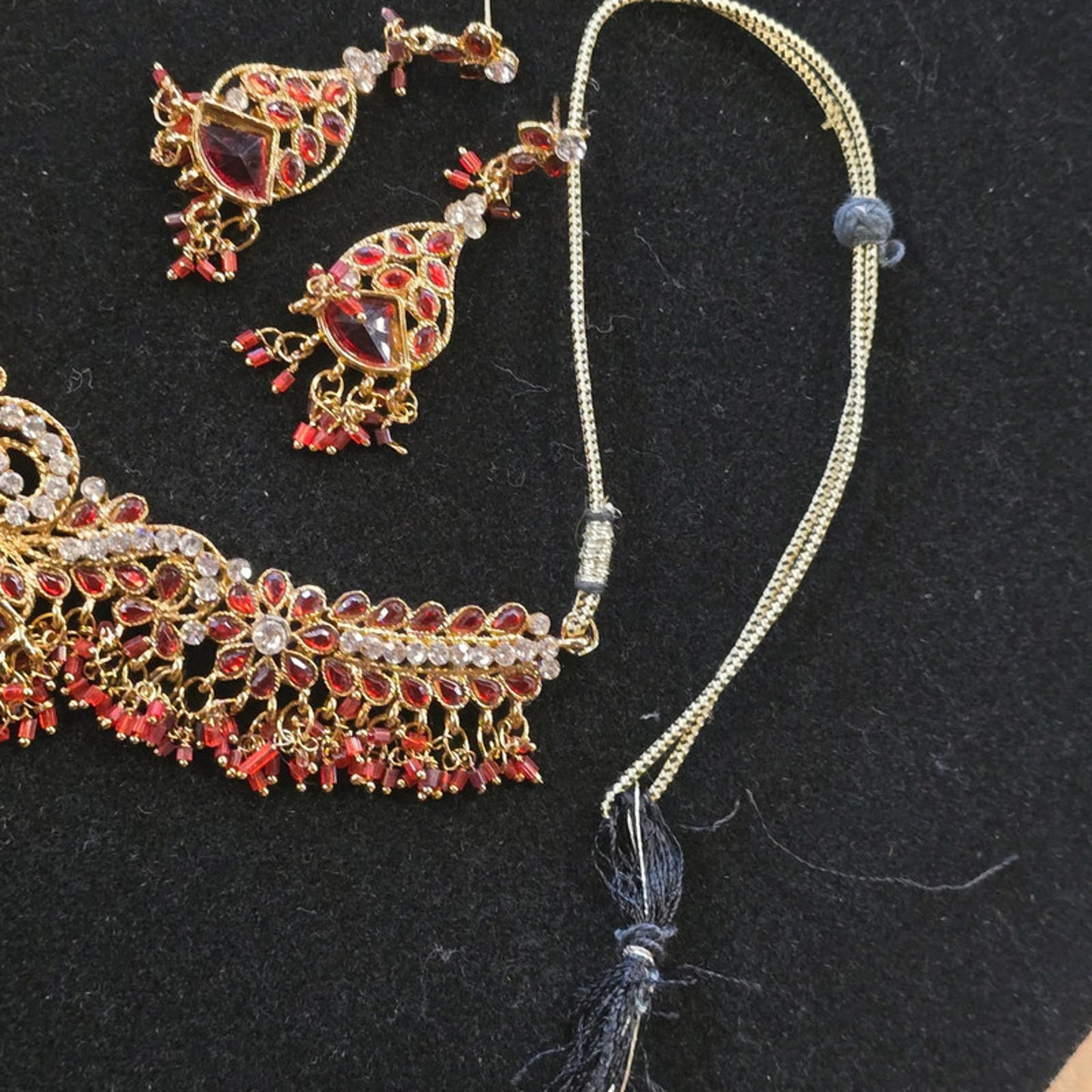 A stunning kundan choker set in gold and red tones