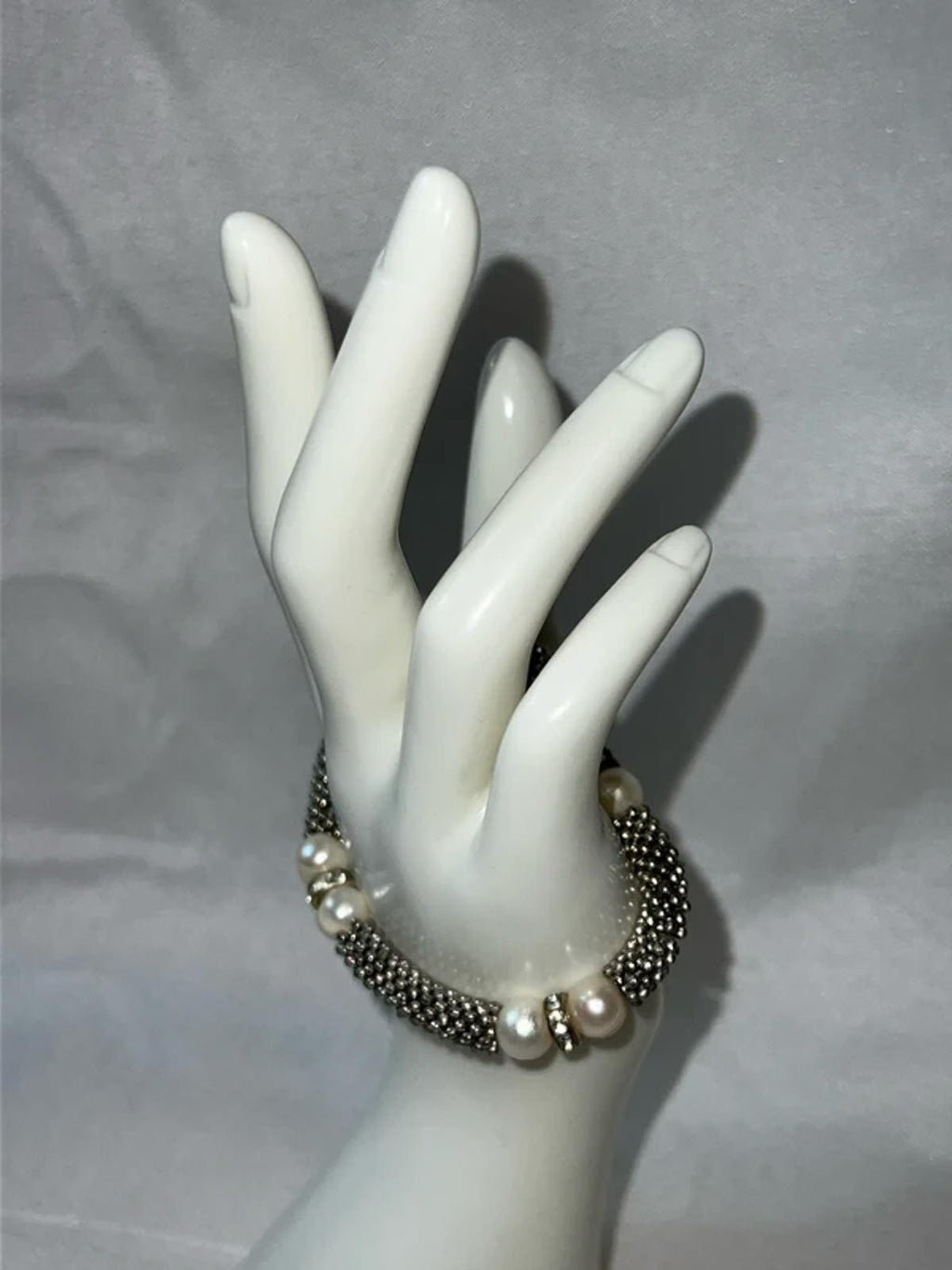 Silver colored bracelet with faux pearls