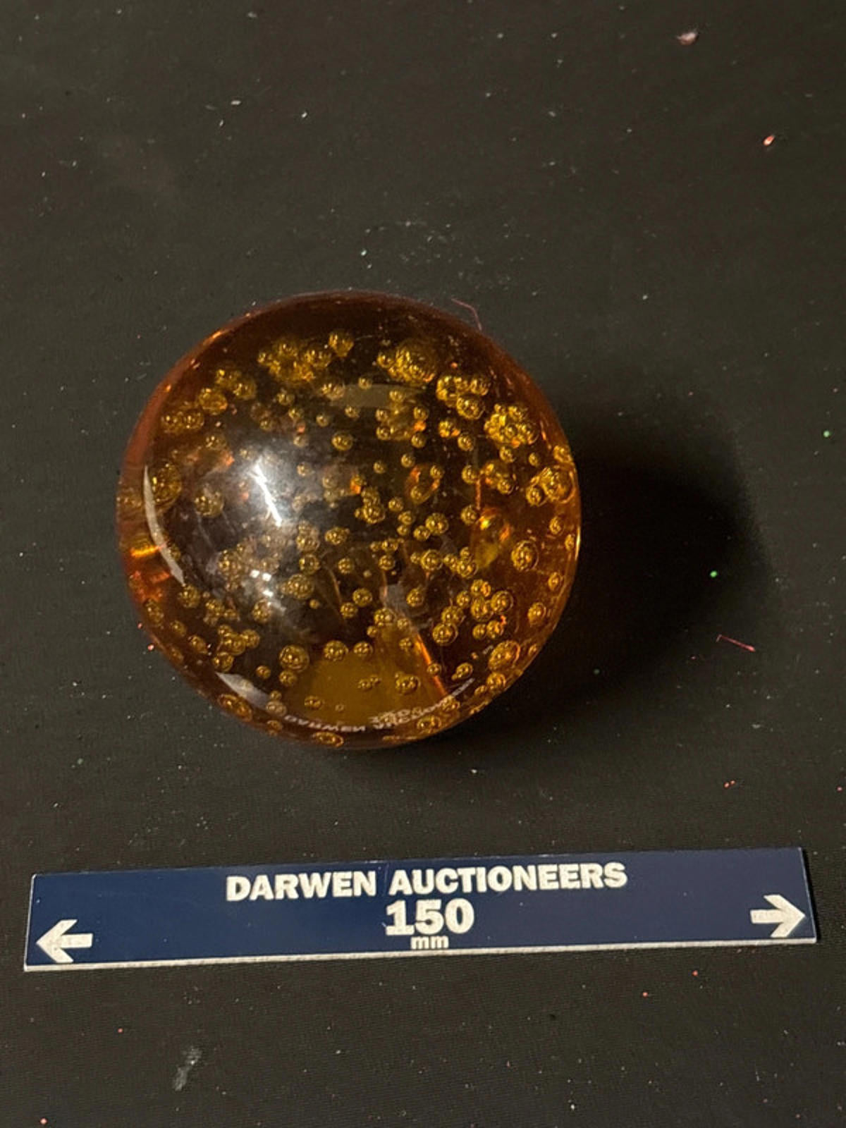 Amber coloured glass paperweight